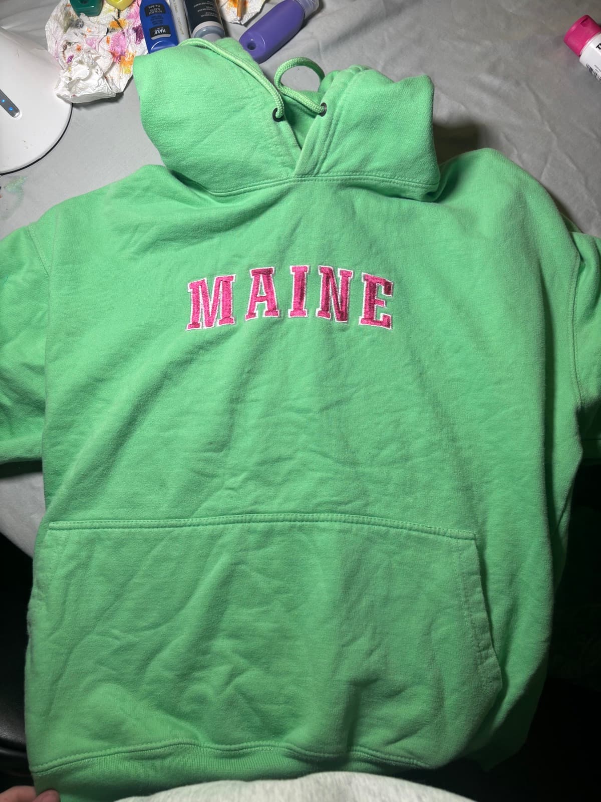 Hand-painted pink sea turtle design, front view, on a custom sweatshirt by Madeleine MacNutt