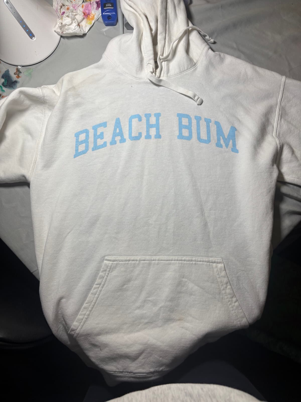 Hand-painted blue crab design, front view, on a custom sweatshirt by Madeleine MacNutt